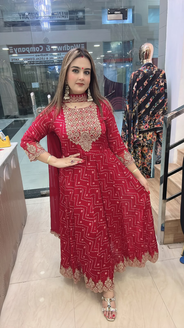Red Chinon Anarkali suit with original mirror work gold lace border and dupatta side pose