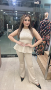 Beige lycra cord set with pearl work peplum top and pants full view